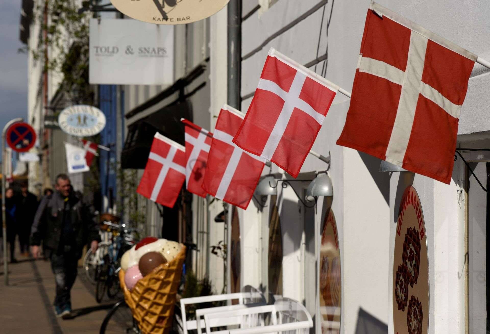 FILE PHOTO: Danish flags are pictured outside a cafe at the famous landmark Nyhavn in Copenhagen, Denmark April 18, 2017. REUTERS/Fabian Bimmer/File Photo