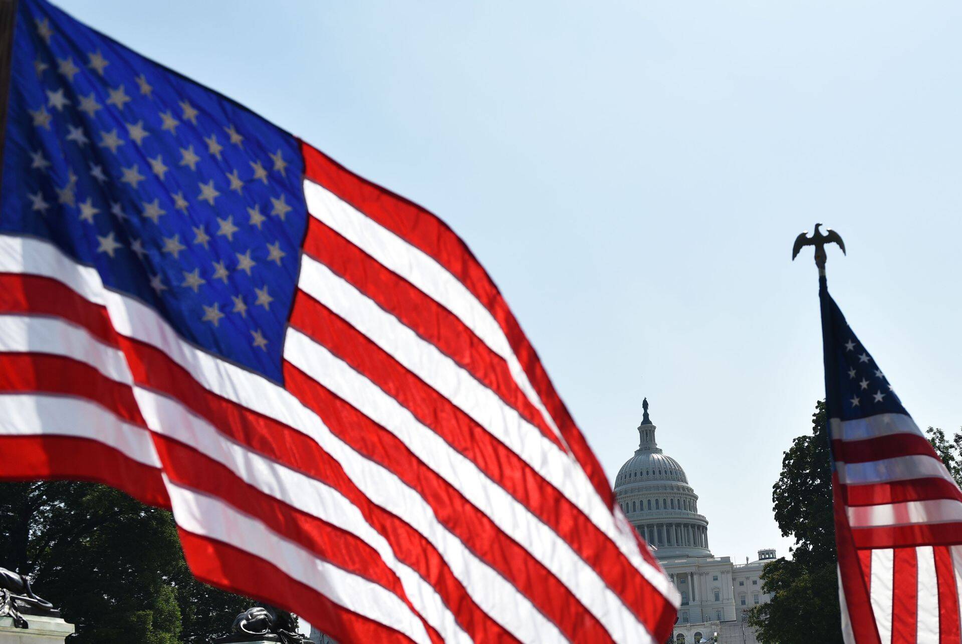 US flags are seen near the Mall in front of the US Capitol in Washington, DC on July 3, 2018, a day ahead of the Independence Day holiday. / AFP PHOTO / Mandel Ngan