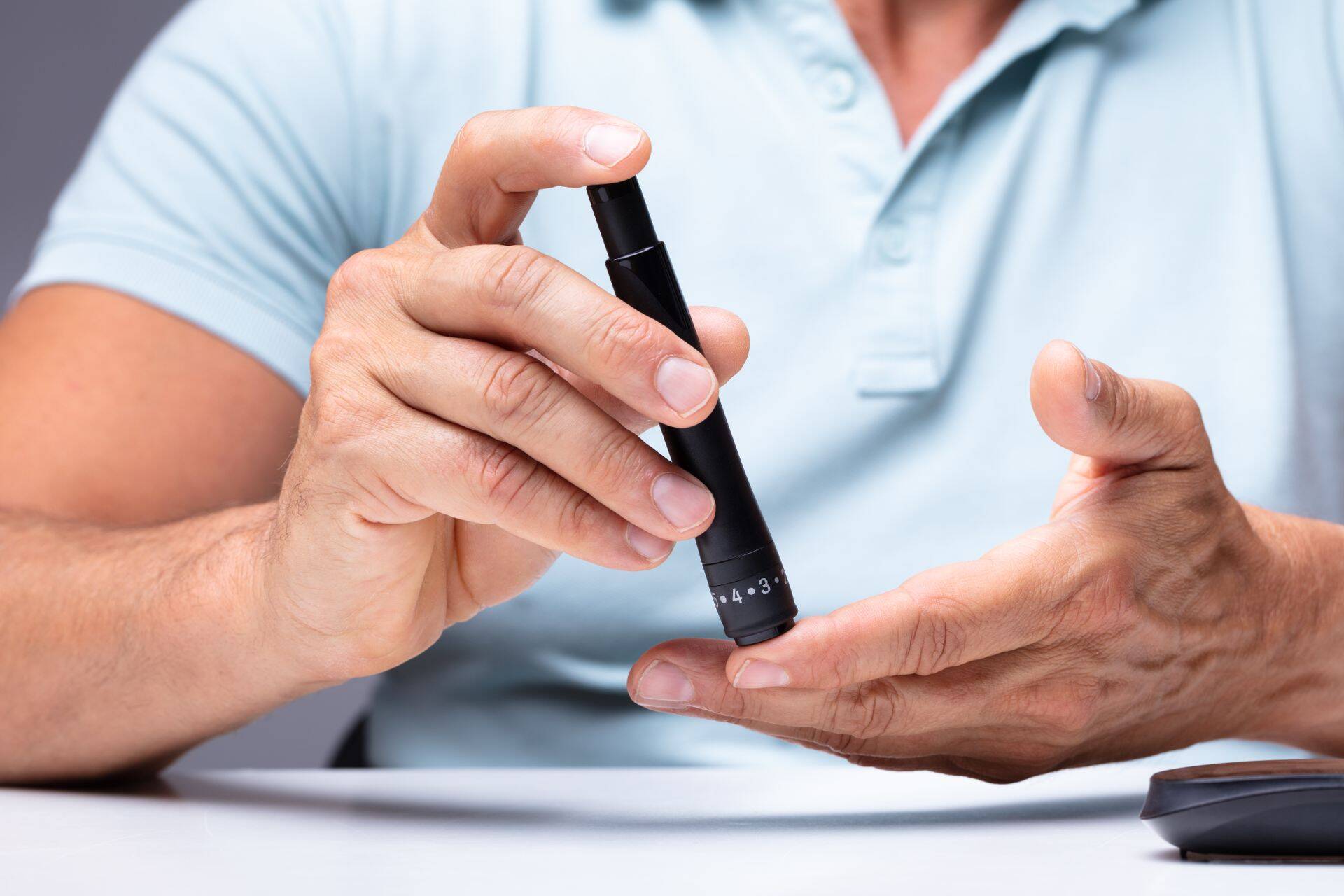 Man Testing High Blood Sugar With Glucometer