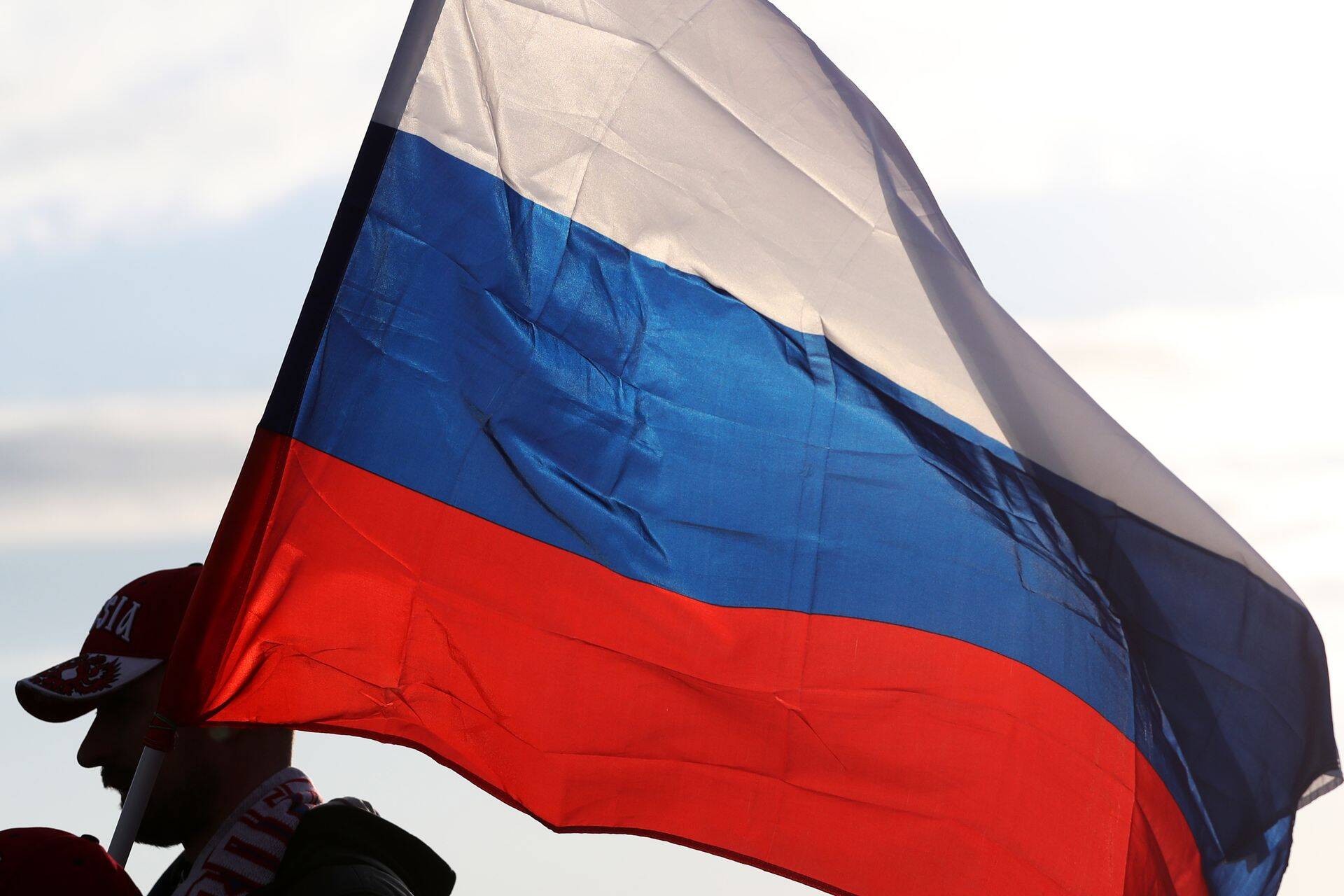SOCHI, RUSSIA - MARCH 28, 2017: A fan carries the Russian flag ahead of a friendly football match between Russia and Belgium at Fisht Stadium. Artyom Korotayev/TASS