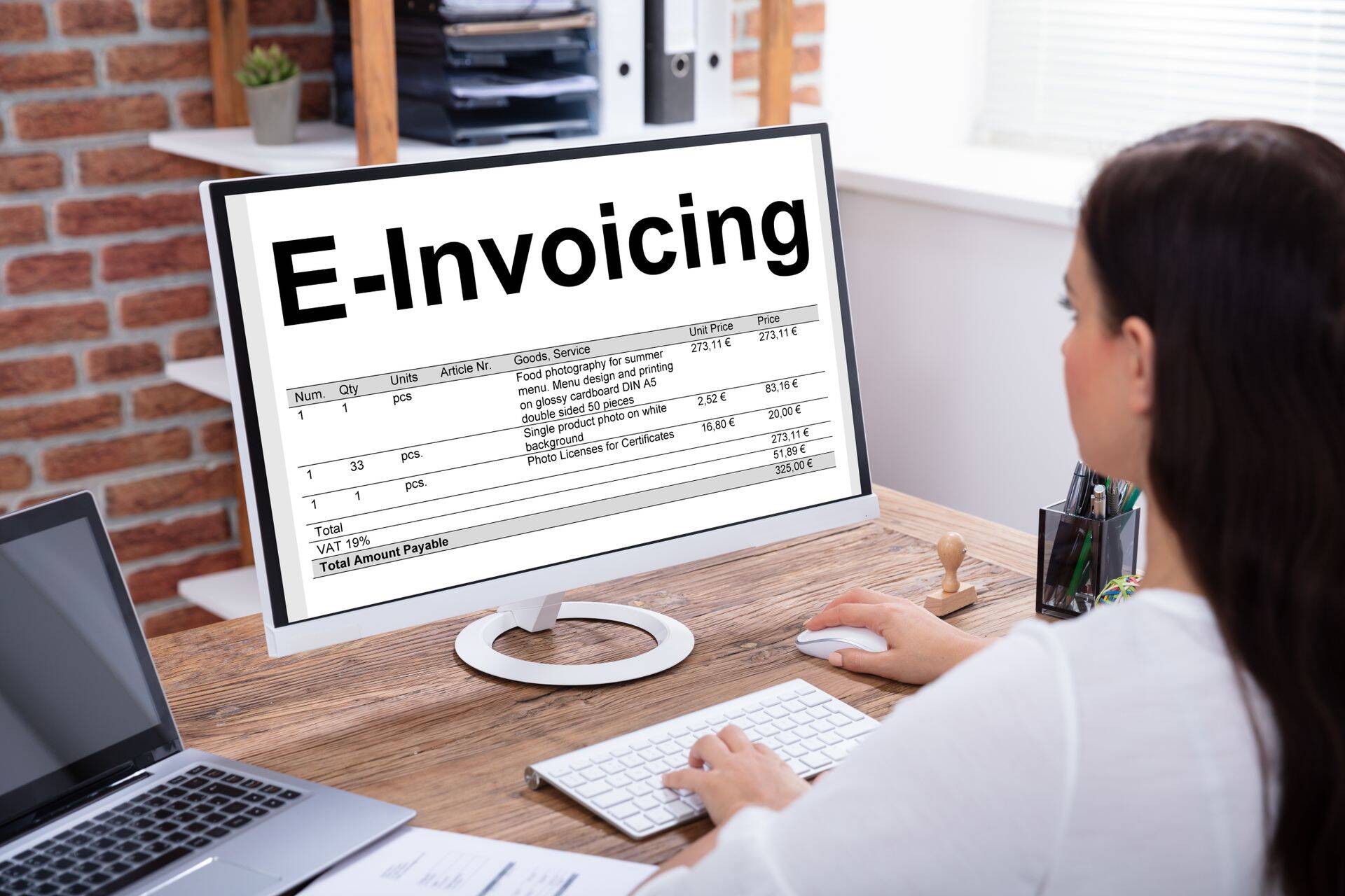 Businesswoman Preparing E-invoicing Bill On Computer
