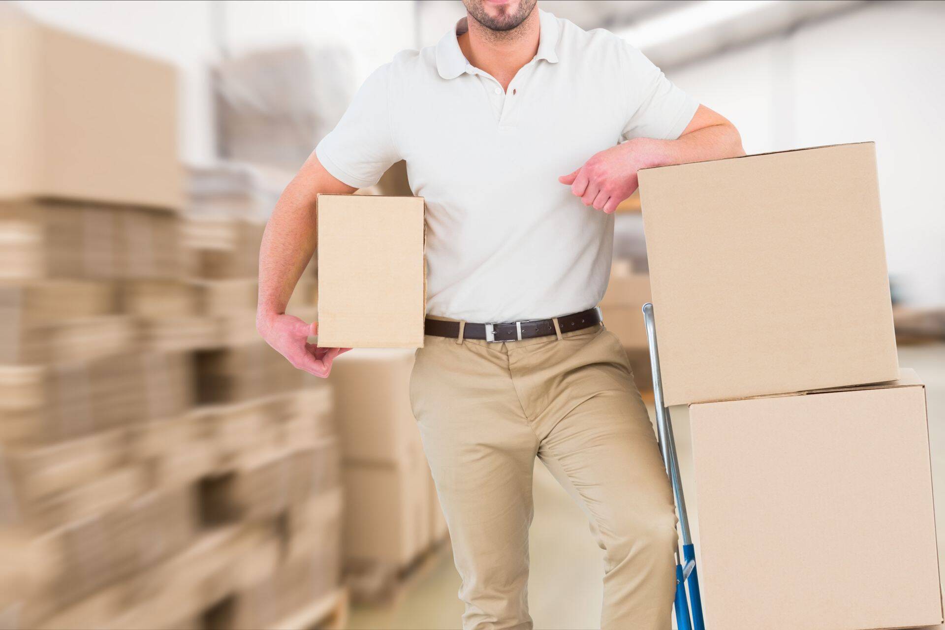 delivery man in warehouse holding package