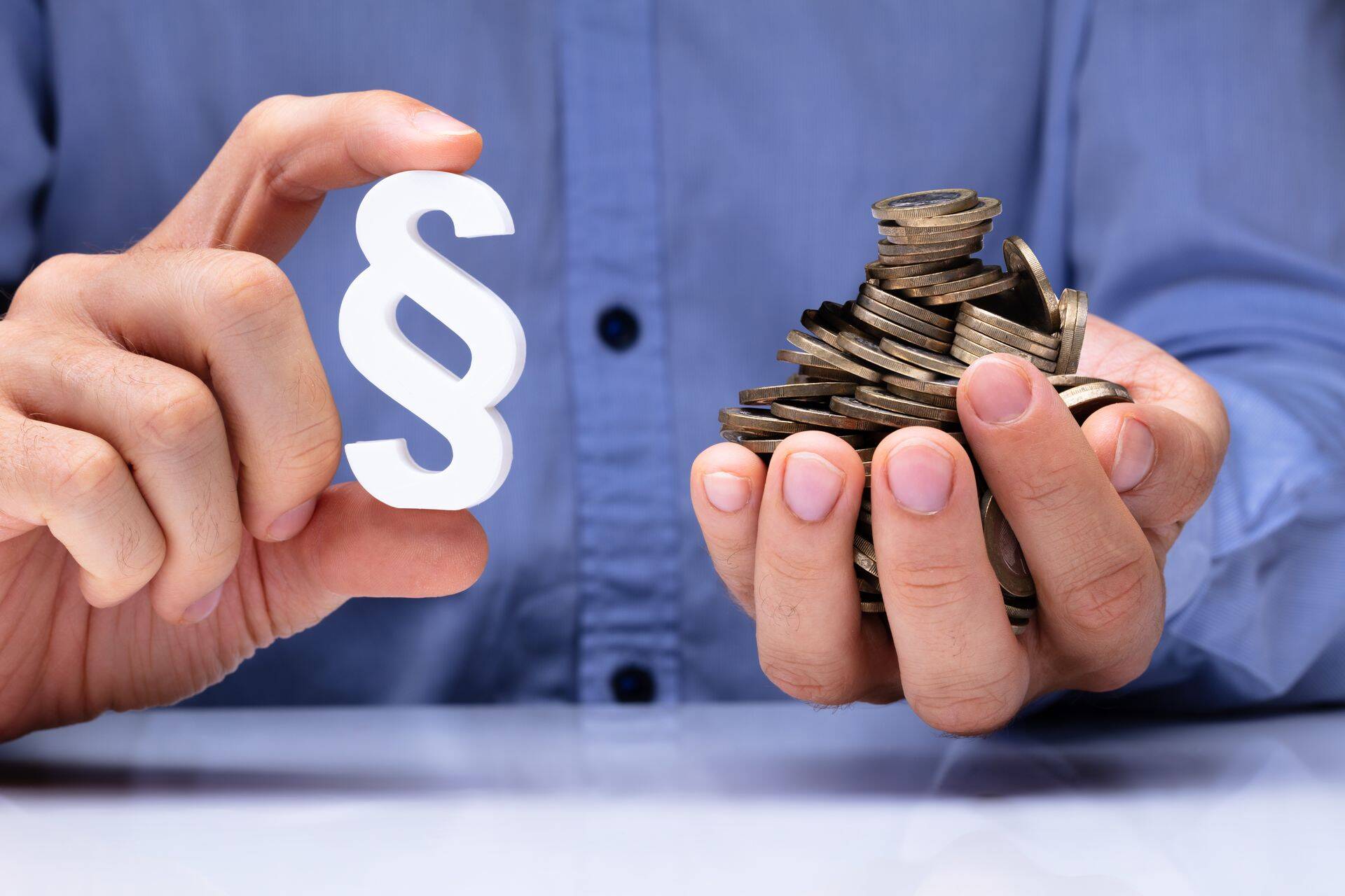 Person Holding Paragraph Symbol And Coins