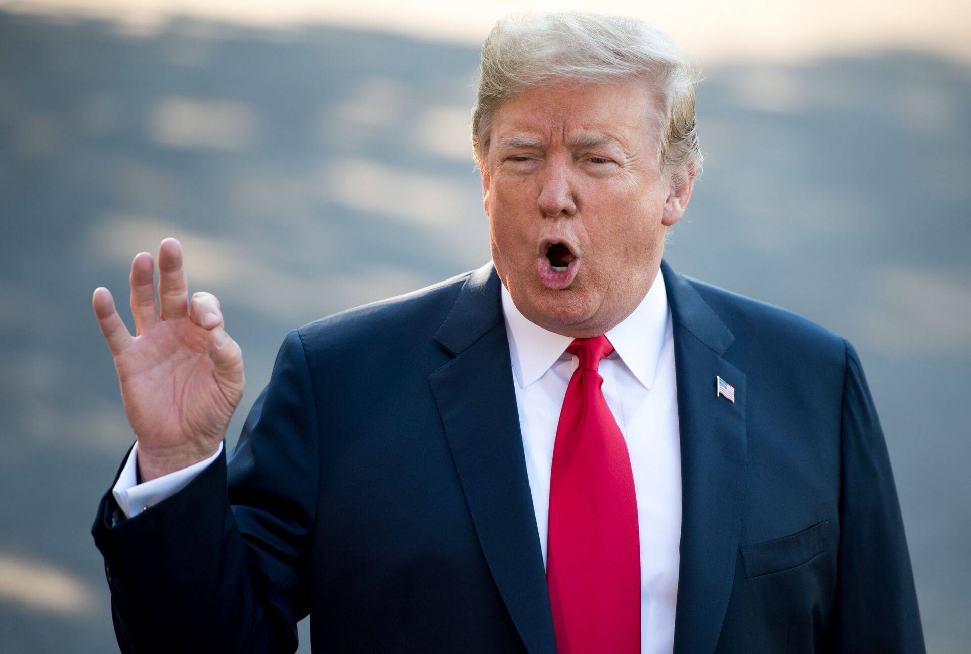 TOPSHOT - US President Donald Trump speaks to the media as he walks to Marine One prior to departure from the South Lawn of the White House in Washington, DC, July 10, 2018, as they travel on a week-long trip to Europe, with stops in Brussels, London, Scotland and Helsinki. / AFP PHOTO / SAUL LOEB