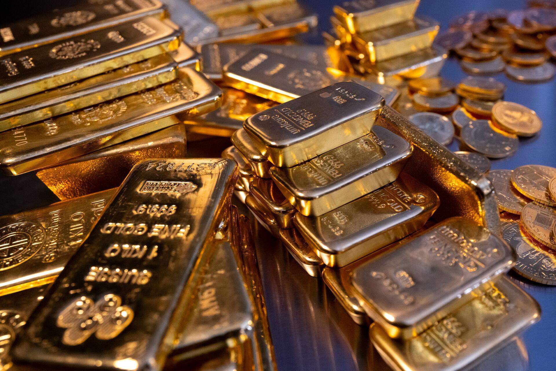 16 March 2023, Bavaria, Munich: Gold bars and gold coins of different sizes lie in a safe on a table at the precious metal dealer Pro Aurum. Photo: Sven Hoppe/dpa