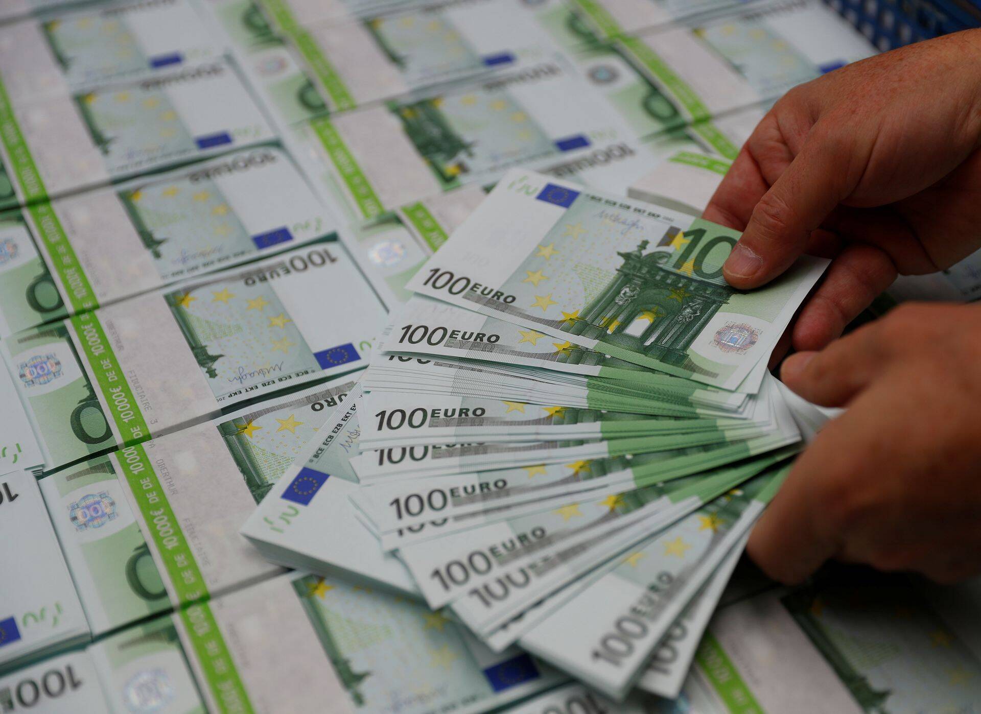 An employee checks 100 Euro banknotes at the Money Service Austria company's headquarters in Vienna, Austria, November 16, 2017. REUTERS/Leonhard Foeger