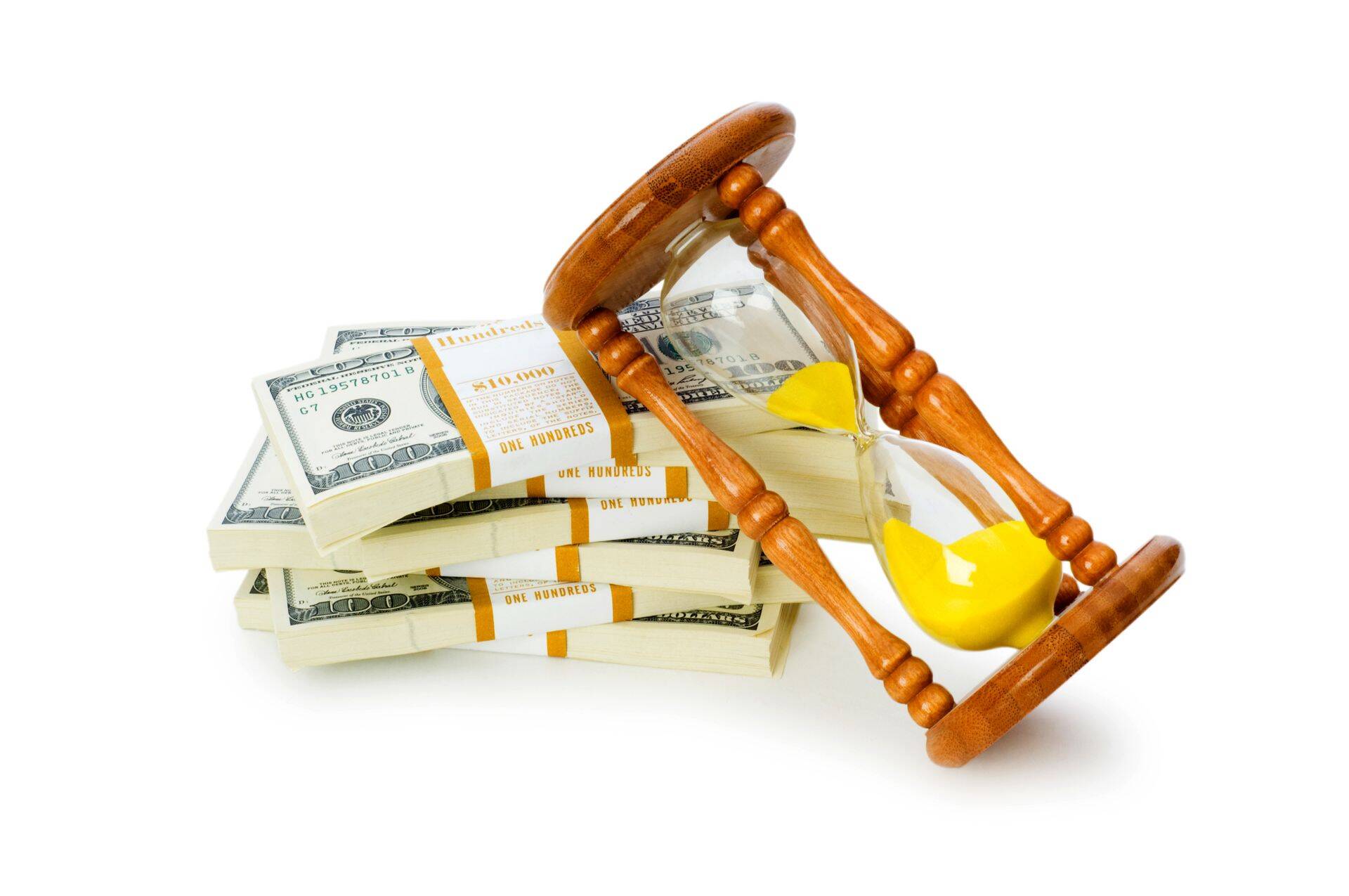 Time is money concept with dollars and hourglass